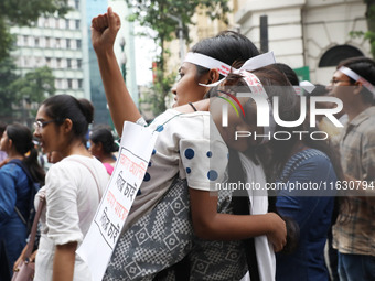 Doctors and citizens hold placards and shout slogans during a protest march against the rape and murder of a PGT woman doctor at Government-...