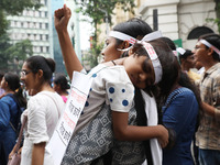 Doctors and citizens hold placards and shout slogans during a protest march against the rape and murder of a PGT woman doctor at Government-...