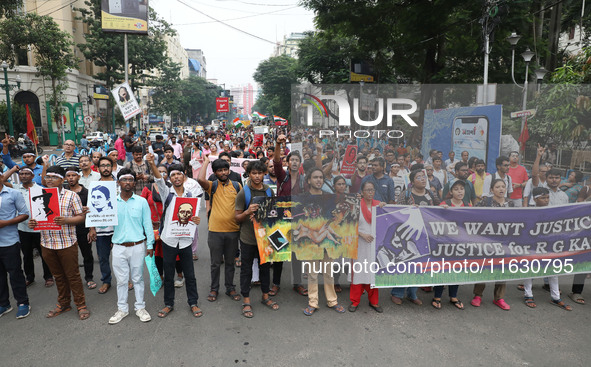 Doctors and citizens hold placards and shout slogans during a protest march against the rape and murder of a PGT woman doctor at Government-...