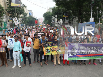 Doctors and citizens hold placards and shout slogans during a protest march against the rape and murder of a PGT woman doctor at Government-...