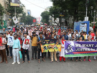 Doctors and citizens hold placards and shout slogans during a protest march against the rape and murder of a PGT woman doctor at Government-...