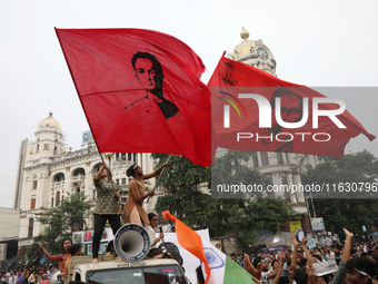 Doctors and citizens hold placards and shout slogans while marching with burning torches during a protest against the rape and murder of a P...