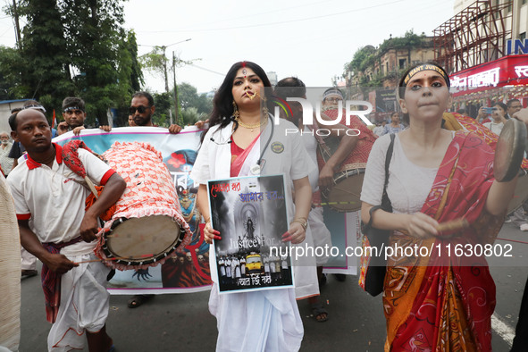 A woman dresses as a doctor and Hindu goddess Durga while doctors and citizens hold placards and shout slogans during a protest march with b...