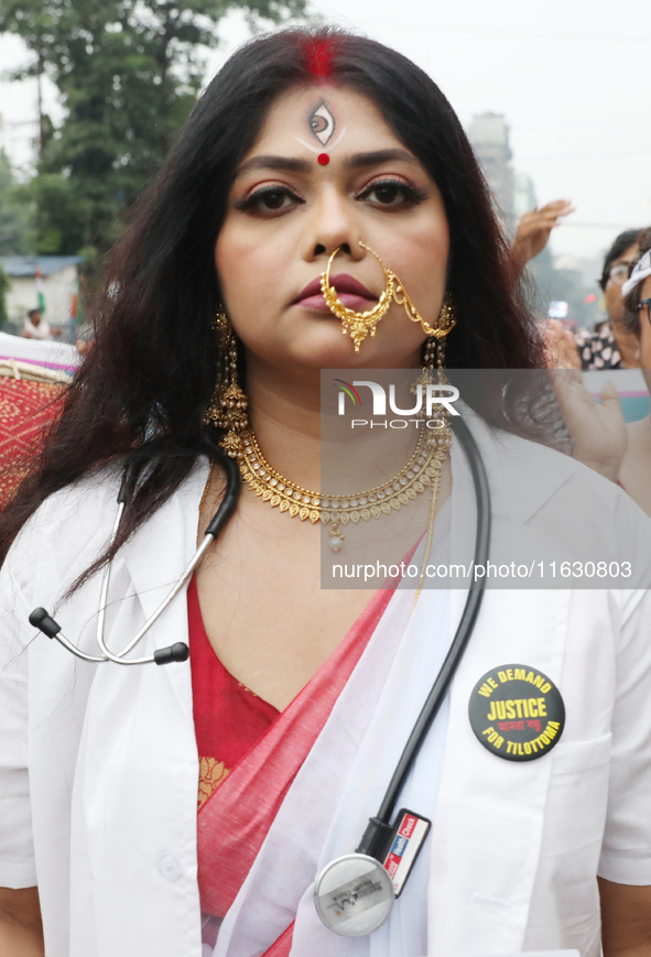 A woman dresses as a doctor and Hindu goddess Durga while doctors and citizens hold placards and shout slogans during a protest march with b...