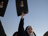 Veiled Iranian women hold portraits of Lebanon's Hezbollah Secretary General Hassan Nasrallah, who was killed in an Israeli airstrike in the...