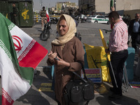 An Iranian woman carries an Iranian flag before a gathering marking the memory of Lebanon's Hezbollah Secretary General, Hassan Nasrallah, a...