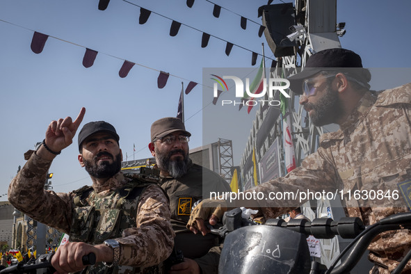 Islamic Revolutionary Guard Corps' (IRGC) special forces talk to each other while monitoring an area before the beginning of a gathering mar...