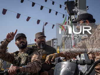 Islamic Revolutionary Guard Corps' (IRGC) special forces talk to each other while monitoring an area before the beginning of a gathering mar...