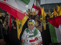 An Iranian woman wearing an Iranian flag looks on while taking part in a gathering marking the memory of Lebanon's Hezbollah Secretary Gener...