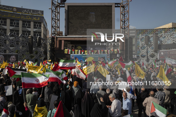 Iranian people wave flags of Lebanon's Hezbollah and Iranian flags during a gathering marking the memory of Nasrallah and an Iranian command...