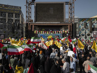 Iranian people wave flags of Lebanon's Hezbollah and Iranian flags during a gathering marking the memory of Nasrallah and an Iranian command...