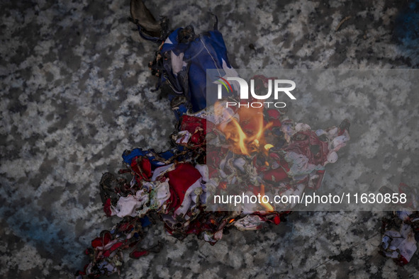 A burnt U.S. flag is pictured during a gathering marking the memory of Lebanon's Hezbollah Secretary General Hassan Nasrallah and an Iranian...