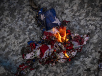 A burnt U.S. flag is pictured during a gathering marking the memory of Lebanon's Hezbollah Secretary General Hassan Nasrallah and an Iranian...