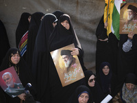 Veiled Iranian women hold portraits of Lebanon's Hezbollah Secretary General Hassan Nasrallah and former IRGC's Quds Force Commander, Genera...