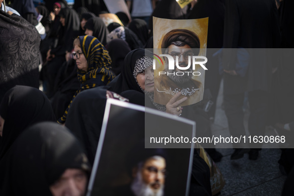 Veiled Iranian women hold portraits of Lebanon's Hezbollah Secretary General Hassan Nasrallah during a gathering marking the memory of Nasra...