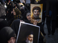 Veiled Iranian women hold portraits of Lebanon's Hezbollah Secretary General Hassan Nasrallah during a gathering marking the memory of Nasra...