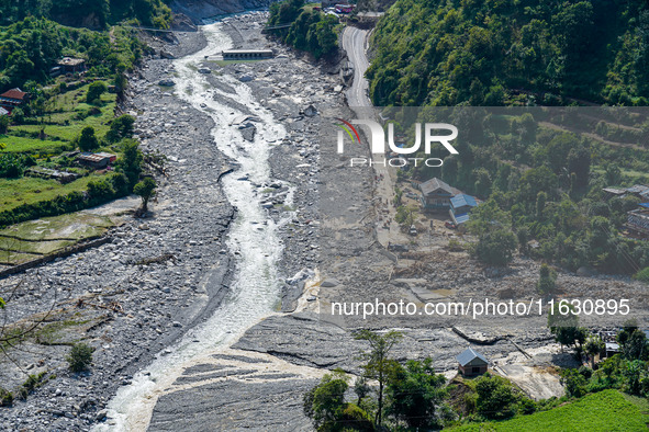 The flooding of the Kulekhani River damages homes and vehicles in Sisneri, Makwanpur, Nepal, on October 2, 2024. Thirty-one homes are comple...