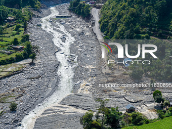 The flooding of the Kulekhani River damages homes and vehicles in Sisneri, Makwanpur, Nepal, on October 2, 2024. Thirty-one homes are comple...