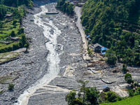 The flooding of the Kulekhani River damages homes and vehicles in Sisneri, Makwanpur, Nepal, on October 2, 2024. Thirty-one homes are comple...