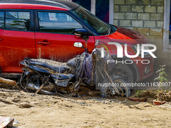 The flooding of the Kulekhani River damages homes and vehicles in Sisneri, Makwanpur, Nepal, on October 2, 2024. (