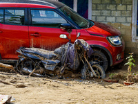 The flooding of the Kulekhani River damages homes and vehicles in Sisneri, Makwanpur, Nepal, on October 2, 2024. (