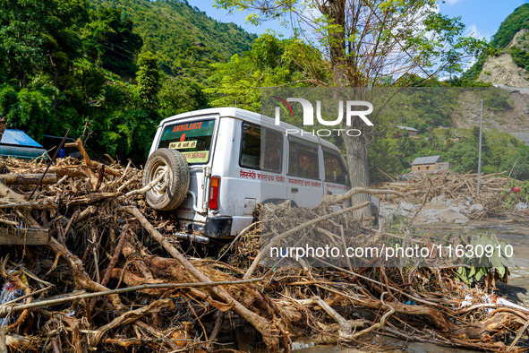 The flooding of the Kulekhani River damages homes and vehicles in Sisneri, Makwanpur, Nepal, on October 2, 2024. 