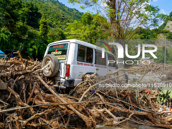 The flooding of the Kulekhani River damages homes and vehicles in Sisneri, Makwanpur, Nepal, on October 2, 2024. (