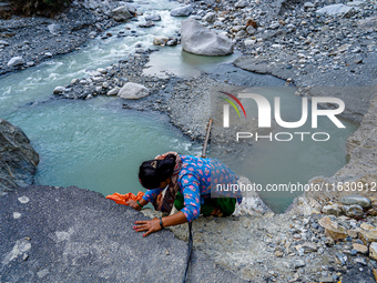 Due to heavy rainfall, the Kulekhani River flood damages the Dakshinkali-Sisneri road in Sisneri, Makwanpur, Nepal, on October 2, 2024. Peop...