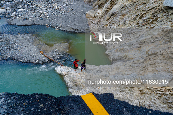 Due to heavy rainfall, the Kulekhani River flood damages the Dakshinkali-Sisneri road in Sisneri, Makwanpur, Nepal, on October 2, 2024. Peop...