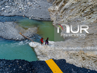 Due to heavy rainfall, the Kulekhani River flood damages the Dakshinkali-Sisneri road in Sisneri, Makwanpur, Nepal, on October 2, 2024. Peop...