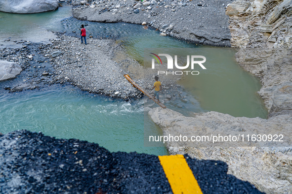 Due to heavy rainfall, the Kulekhani River flood damages the Dakshinkali-Sisneri road in Sisneri, Makwanpur, Nepal, on October 2, 2024. Peop...