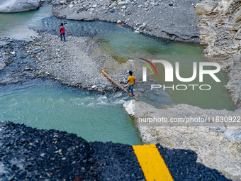 Due to heavy rainfall, the Kulekhani River flood damages the Dakshinkali-Sisneri road in Sisneri, Makwanpur, Nepal, on October 2, 2024. Peop...