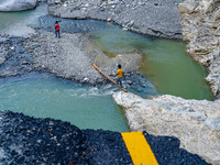 Due to heavy rainfall, the Kulekhani River flood damages the Dakshinkali-Sisneri road in Sisneri, Makwanpur, Nepal, on October 2, 2024. Peop...