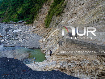 Due to heavy rainfall, the Kulekhani River flood damages the Dakshinkali-Sisneri road in Sisneri, Makwanpur, Nepal, on October 2, 2024. Peop...