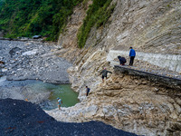 Due to heavy rainfall, the Kulekhani River flood damages the Dakshinkali-Sisneri road in Sisneri, Makwanpur, Nepal, on October 2, 2024. Peop...