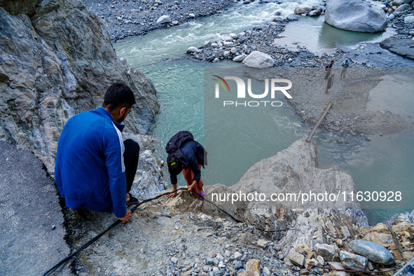 Due to heavy rainfall, the Kulekhani River flood damages the Dakshinkali-Sisneri road in Sisneri, Makwanpur, Nepal, on October 2, 2024. Peop...