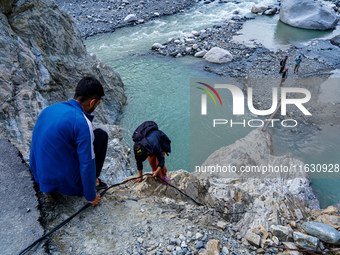 Due to heavy rainfall, the Kulekhani River flood damages the Dakshinkali-Sisneri road in Sisneri, Makwanpur, Nepal, on October 2, 2024. Peop...