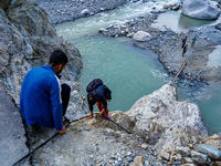 Due to heavy rainfall, the Kulekhani River flood damages the Dakshinkali-Sisneri road in Sisneri, Makwanpur, Nepal, on October 2, 2024. Peop...