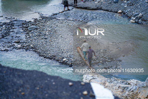 Due to heavy rainfall, the Kulekhani River flood damages the Dakshinkali-Sisneri road in Sisneri, Makwanpur, Nepal, on October 2, 2024. Peop...