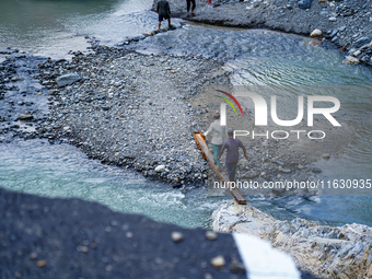 Due to heavy rainfall, the Kulekhani River flood damages the Dakshinkali-Sisneri road in Sisneri, Makwanpur, Nepal, on October 2, 2024. Peop...