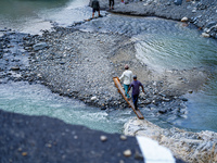 Due to heavy rainfall, the Kulekhani River flood damages the Dakshinkali-Sisneri road in Sisneri, Makwanpur, Nepal, on October 2, 2024. Peop...