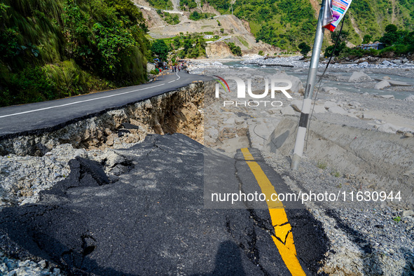 Due to heavy rainfall, the Kulekhani River flood damages the Dakshinkali-Sisneri road in Sisneri, Makwanpur, Nepal, on October 2, 2024. 