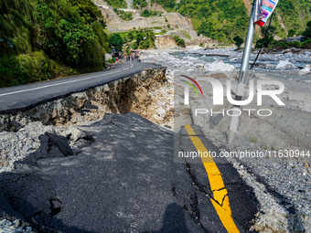 Due to heavy rainfall, the Kulekhani River flood damages the Dakshinkali-Sisneri road in Sisneri, Makwanpur, Nepal, on October 2, 2024. (