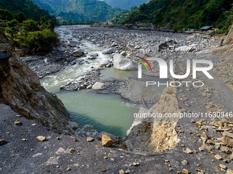 Due to heavy rainfall, the Kulekhani River flood damages the Dakshinkali-Sisneri road in Sisneri, Makwanpur, Nepal, on October 2, 2024. (