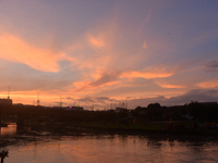 People and vehicles are seen as the sun sets in Siliguri, India, on October 2, 2024. (