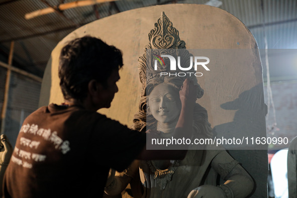 Artisans make idols ahead of Durga Puja in Dhaka, Bangladesh, on October 2, 2024. 