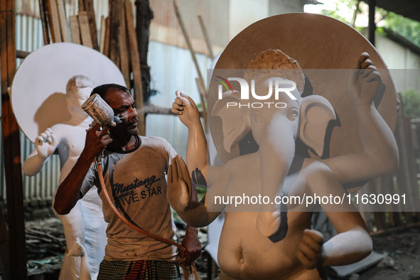 Artisans make idols ahead of Durga Puja in Dhaka, Bangladesh, on October 2, 2024. 