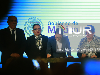 Claudia Sheinbaum Pardo, the first female President of Mexico, signs her first decree, a public apology for the student massacre of 1968, an...