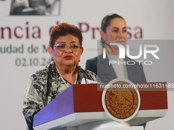 Claudia Sheinbaum Pardo, the first female President of Mexico, stands behind while Ernestina Godoy, legal advisor of the Government of Mexic...