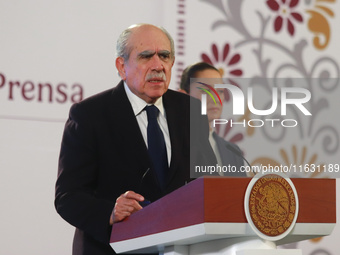 Claudia Sheinbaum Pardo, the first female President of Mexico, stands behind while Pablo Gomez, director of the Financial Intelligence Unit...